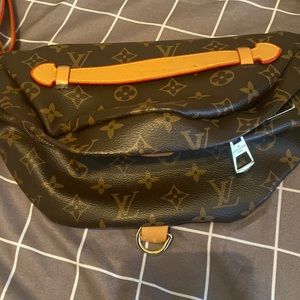 A brown Louis Vuitton cross hand bag in great condition used just once.